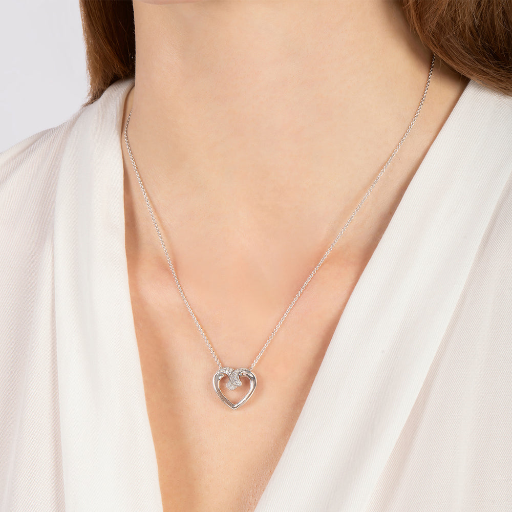 Hallmarkfinejewelry Hugging Heart Pendant in Sterling Silver with 1/6 Cttw of Diamonds